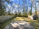 Large, fenced backyard with a patio area, shed, and plenty of green space at 1764 Springview Nw Rd, Atlanta, GA 30314