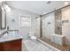 Modern bathroom featuring a glass bowl sink, granite counters, and walk-in shower with mosaic tile accents at 1764 Springview Nw Rd, Atlanta, GA 30314