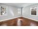 Bright bedroom featuring wood floors, neutral paint, and natural light from multiple windows at 1764 Springview Nw Rd, Atlanta, GA 30314