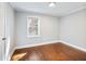 Bedroom featuring neutral paint, wood floors, and a window providing natural light at 1764 Springview Nw Rd, Atlanta, GA 30314