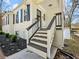 Charming exterior features white painted brick, black shutters, and inviting front entrance with wooden stairs at 1764 Springview Nw Rd, Atlanta, GA 30314