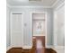 Hallway with wood floors, a closet, and neutral paint leading to another room with natural light at 1764 Springview Nw Rd, Atlanta, GA 30314