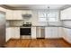 Renovated kitchen with granite countertops, stainless steel appliances, and white cabinets at 1764 Springview Nw Rd, Atlanta, GA 30314