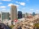 Aerial view of townhomes, parking deck and high-rise buildings in a vibrant cityscape at 223 16Th Nw St # 2, Atlanta, GA 30363