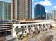 Aerial view of townhomes, parking deck and high-rise buildings in a vibrant cityscape at 223 16Th Nw St # 2, Atlanta, GA 30363