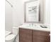 Bathroom featuring a modern vanity with a marble countertop, complemented by a silver-framed mirror and tiled shower at 223 16Th Nw St # 2, Atlanta, GA 30363