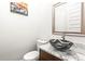 Stylish powder room featuring marble countertop, vessel sink, modern faucet, and framed mirror at 223 16Th Nw St # 2, Atlanta, GA 30363