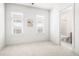 Bright bedroom with fresh white paint, neutral carpet, and two large windows showcasing natural light at 223 16Th Nw St # 2, Atlanta, GA 30363