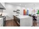 Open-concept kitchen with large island, stainless steel appliances, and adjacent dining area at 223 16Th Nw St # 2, Atlanta, GA 30363