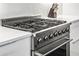 Close-up of a professional-grade stainless steel gas range stove top with white countertops at 223 16Th Nw St # 2, Atlanta, GA 30363