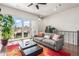 Bright living room with a modern gray sofa, dark floors, and sliding glass doors leading to a balcony at 223 16Th Nw St # 2, Atlanta, GA 30363