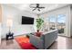 Cozy living room with a modern sofa and a large TV, complemented by a bright rug and sliding doors to the patio at 223 16Th Nw St # 2, Atlanta, GA 30363
