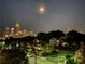 Stunning skyline view at night with illuminated skyscrapers, tree lined streets, and the soft glow of city lights at 223 16Th Nw St # 2, Atlanta, GA 30363