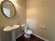 Half-bathroom featuring hardwood floors, pedestal sink and toilet at 2643 Winslow Ridge Dr, Buford, GA 30519