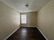 A modest bedroom featuring wood-look flooring and a window at 2643 Winslow Ridge Dr, Buford, GA 30519