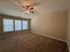 Large main bedroom featuring neutral walls, carpet, ceiling fan, and windows at 2643 Winslow Ridge Dr, Buford, GA 30519