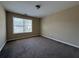 Bedroom with neutral walls, carpet floors, and a large window at 2643 Winslow Ridge Dr, Buford, GA 30519