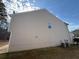 Side view of two-story home featuring vinyl siding and small window at 2643 Winslow Ridge Dr, Buford, GA 30519