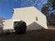 Side view of home with vinyl siding, green shrub, and gas meter at 2643 Winslow Ridge Dr, Buford, GA 30519