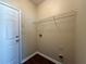 Laundry room with white door, overhead wire rack, and washer/dryer hookups at 2643 Winslow Ridge Dr, Buford, GA 30519