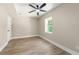 Bedroom featuring light wood floors, neutral paint, a ceiling fan, and a window at 2682 Miriam Ln, Decatur, GA 30032