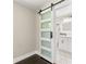 Hallway with a sliding barn door that reveals an illuminated bathroom at 2682 Miriam Ln, Decatur, GA 30032