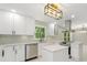 Bright kitchen featuring white cabinets, stainless steel appliances, and modern light fixtures at 2682 Miriam Ln, Decatur, GA 30032