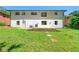 Spacious backyard featuring green grass, a wooden deck, and mature trees at 2682 Miriam Ln, Decatur, GA 30032