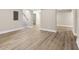 Spacious basement area with neutral paint, a staircase, and light wood-look flooring at 2682 Miriam Ln, Decatur, GA 30032