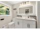 Bright bathroom with double sinks, sleek illuminated mirror, and modern fixtures at 2682 Miriam Ln, Decatur, GA 30032
