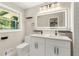 Modern bathroom featuring a dual sink vanity, and mirror at 2682 Miriam Ln, Decatur, GA 30032