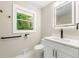 Elegant bathroom with a modern vanity, backlit mirror, and sleek fixtures at 2682 Miriam Ln, Decatur, GA 30032