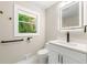 Modern bathroom featuring sleek fixtures, illuminated mirror, and natural light from the window at 2682 Miriam Ln, Decatur, GA 30032
