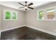 This large bedroom features updated flooring and plenty of natural light from two large windows at 2682 Miriam Ln, Decatur, GA 30032