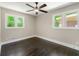 Cozy bedroom with hardwood floors, neutral walls, and bright natural light from the windows at 2682 Miriam Ln, Decatur, GA 30032