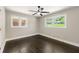 Bedroom with hardwood floors, neutral walls, bright windows, and overhead fan at 2682 Miriam Ln, Decatur, GA 30032
