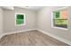 Cozy bedroom with two bright windows and wood-look floors that fills the space with light at 2682 Miriam Ln, Decatur, GA 30032