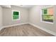 Bright bedroom featuring two windows and modern flooring at 2682 Miriam Ln, Decatur, GA 30032