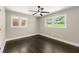 Bedroom featuring wood floors, two windows, and a ceiling fan at 2682 Miriam Ln, Decatur, GA 30032