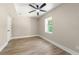Bedroom featuring a ceiling fan, window, and modern flooring at 2682 Miriam Ln, Decatur, GA 30032