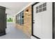Front entry of home featuring a brick facade, a modern light fixture, and a white front door at 2682 Miriam Ln, Decatur, GA 30032