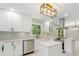Bright kitchen with white cabinets, stainless steel appliances, and eye-catching backsplash tiles at 2682 Miriam Ln, Decatur, GA 30032