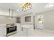 Well-lit kitchen features new stainless steel appliances, white cabinetry, and a central island at 2682 Miriam Ln, Decatur, GA 30032
