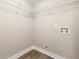 Practical laundry room with wire shelving, utility hookups, and neutral paint, offering functionality and storage at 2682 Miriam Ln, Decatur, GA 30032