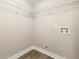 The laundry room provides functionality with its overhead shelving, new floor, and convenient washer hookups at 2682 Miriam Ln, Decatur, GA 30032