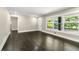 Bright living room with dark hardwood floors and large windows offering views of the neighborhood at 2682 Miriam Ln, Decatur, GA 30032