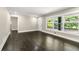 Open-concept living room featuring dark hardwood floors and large windows at 2682 Miriam Ln, Decatur, GA 30032