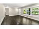 Bright living room featuring hardwood floors, large windows, and neutral walls with white trim at 2682 Miriam Ln, Decatur, GA 30032