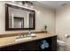 Well-lit bathroom with a granite countertop, wood cabinets, framed mirror, and decorative towels at 2871 Parkridge Ne Dr, Brookhaven, GA 30319