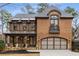 Stunning two-story brick home with a covered porch and stone accents creates a welcoming and elegant facade at 2871 Parkridge Ne Dr, Brookhaven, GA 30319